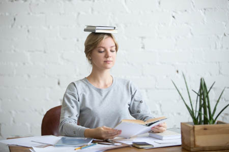 woman with good posture balancing book on head